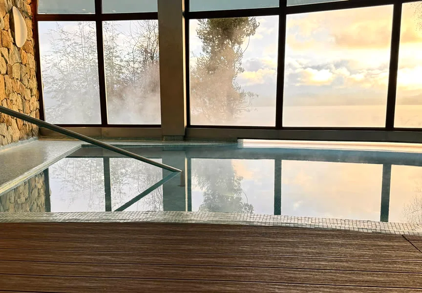 Indoor heated pool with panoramic lake and sunset views at Design Suites Hotel Patagonia, Bariloche