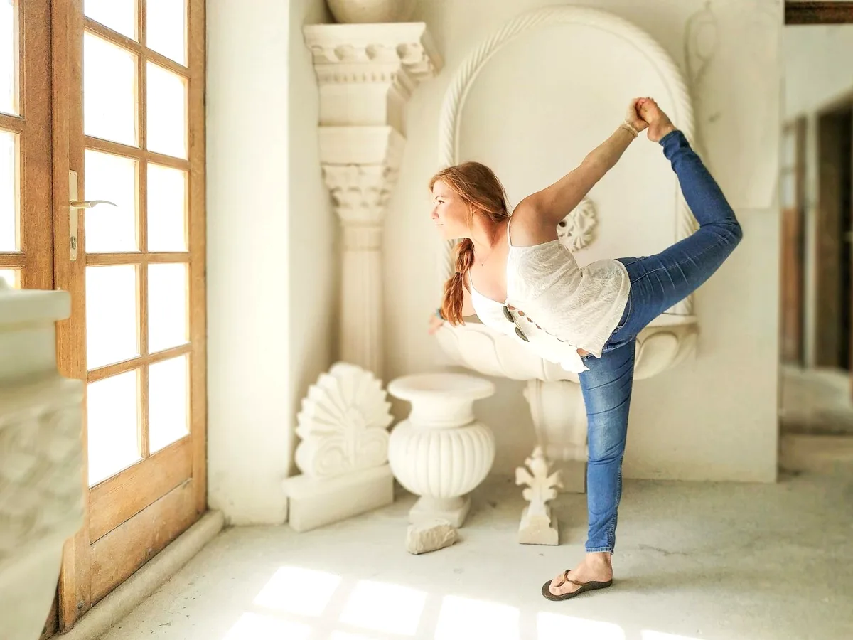 Standing bow yoga pose inside the Pučišća stonemasonry school, Brač Island