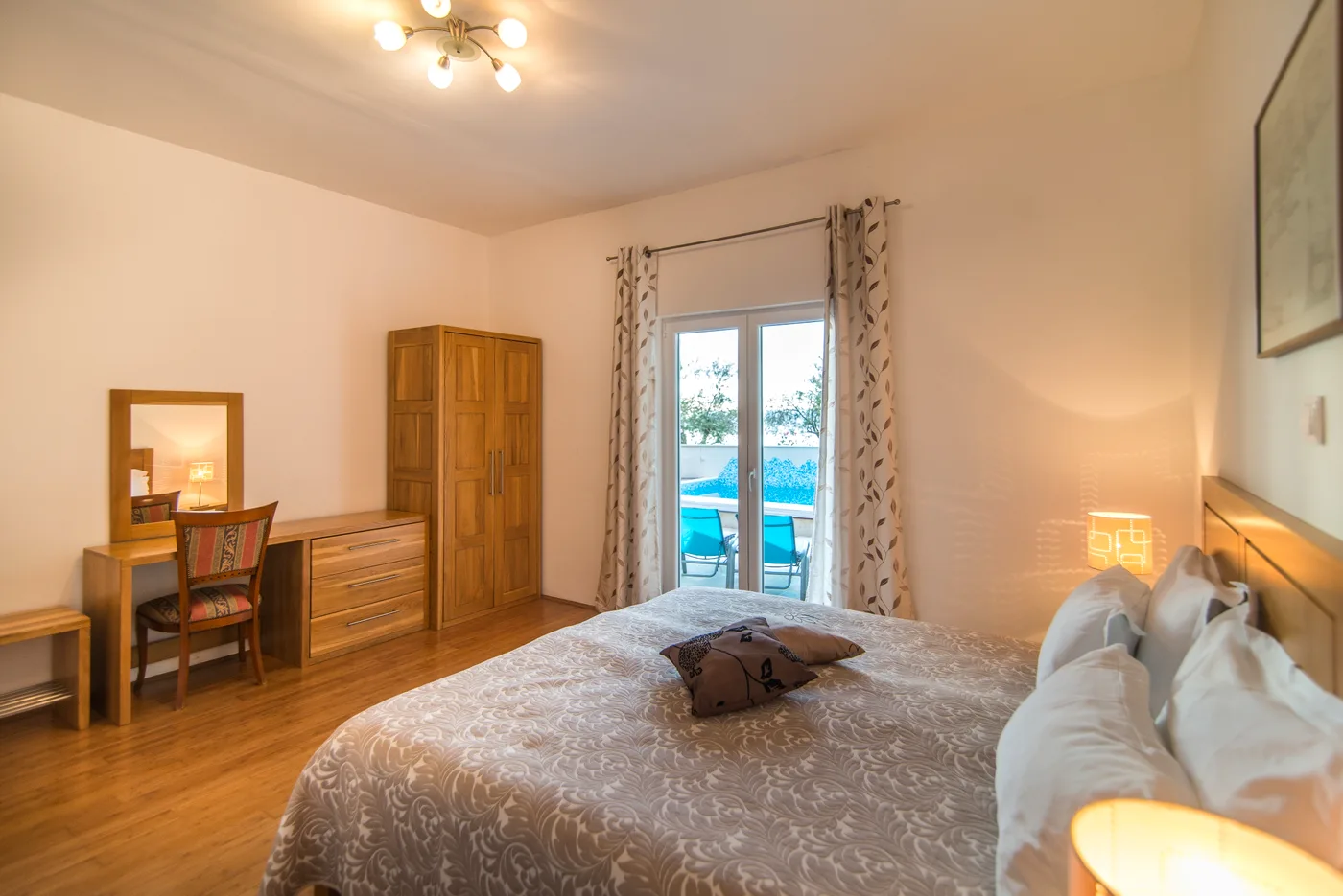 En-suite bedroom with pool-view balcony at Villa Mirca, Brač Island