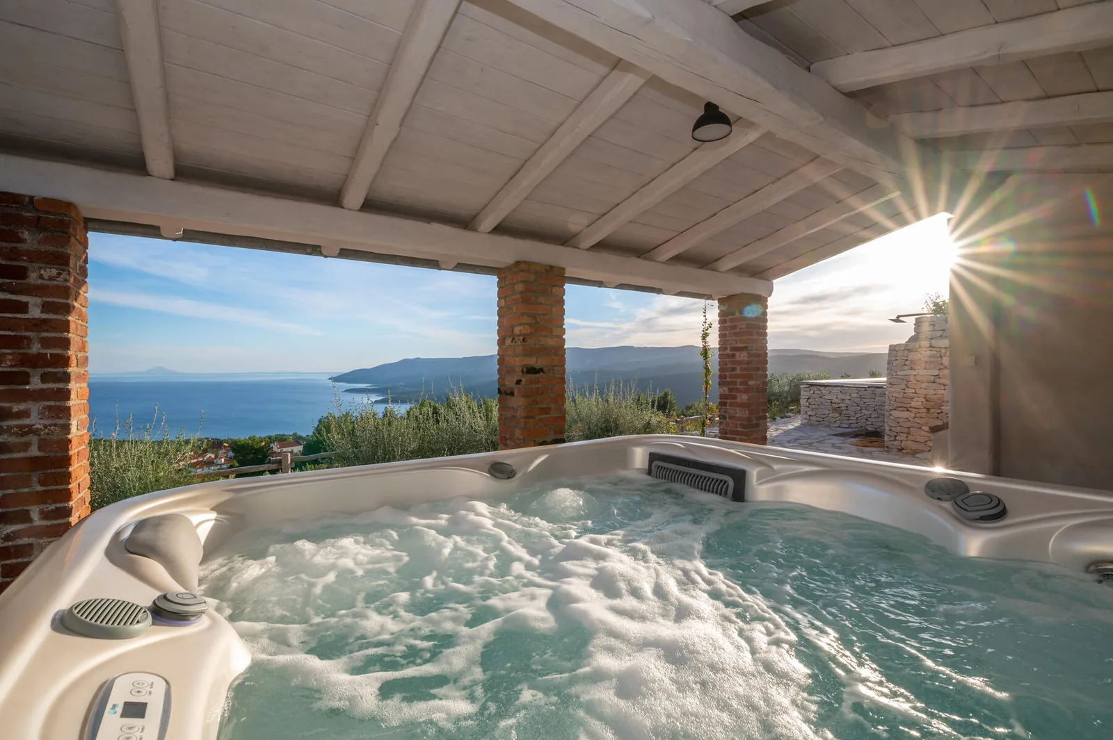 Jacuzzi on the covered terrace with a view of the sea at the villa in Rabac