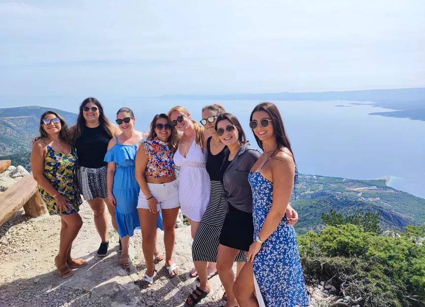 Group of women on a hilltop with Croatian coastline panorama — Croatia Vegan Tour