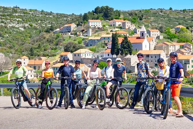 E-biking group stopped at a hill village on Hvar Island, Croatia