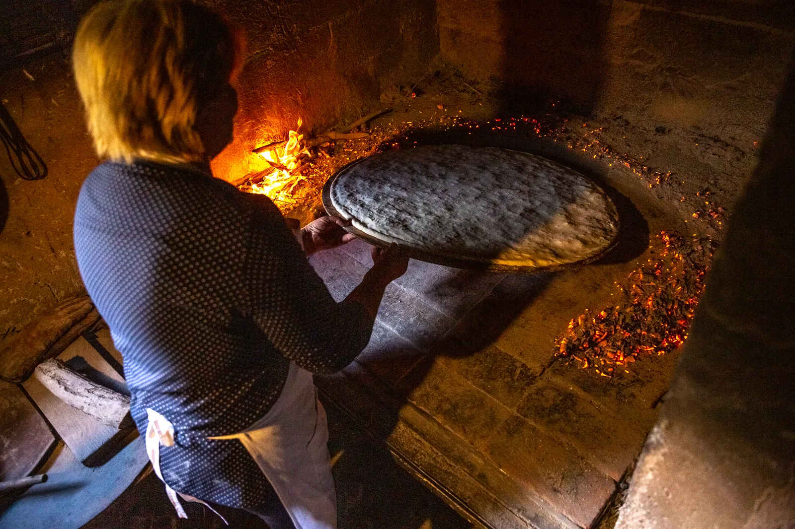 Soparnik, a traditional Dalmatian chard pie, baking under hot coals at a cooking class, Croatia
