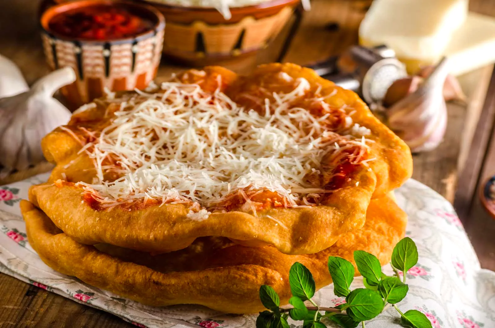 Traditional Hungarian langós, fried bread topped with cheese — vegetarian by nature