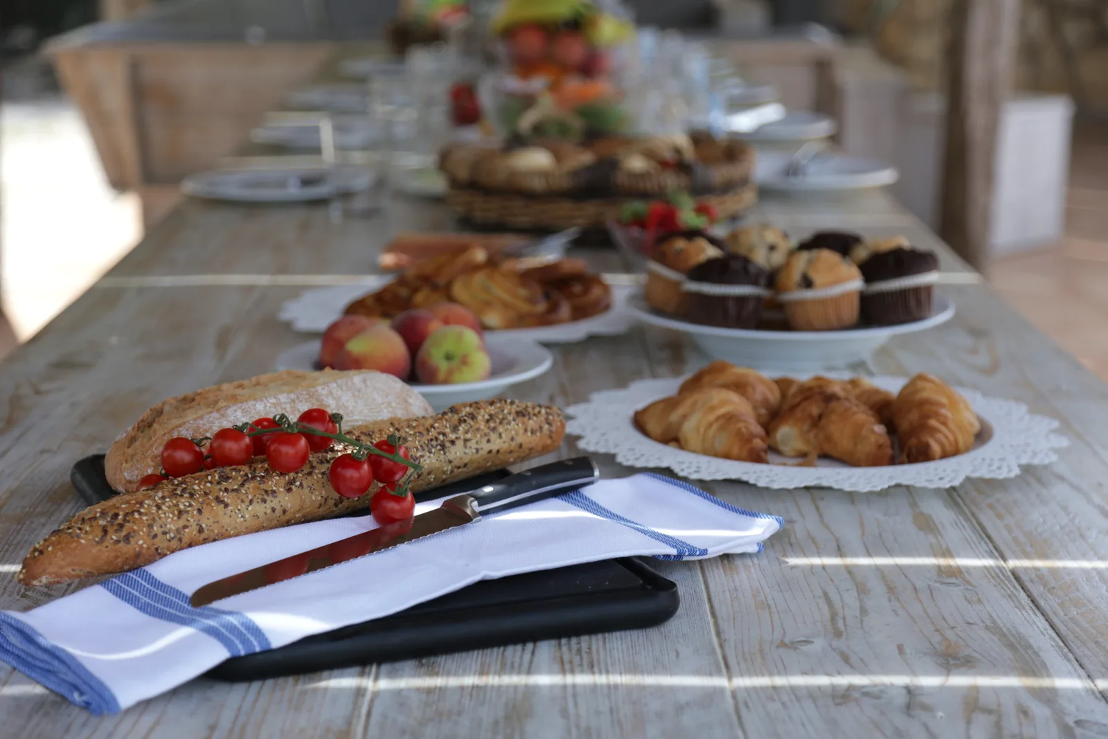 Outdoor breakfast spread of bread, pastries and fresh fruit at the Oodles villa, Spain