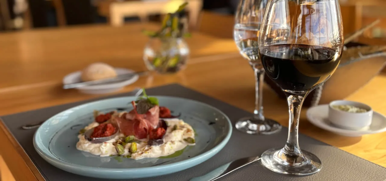 Plated dish and wine at a restaurant near Bariloche, Argentina