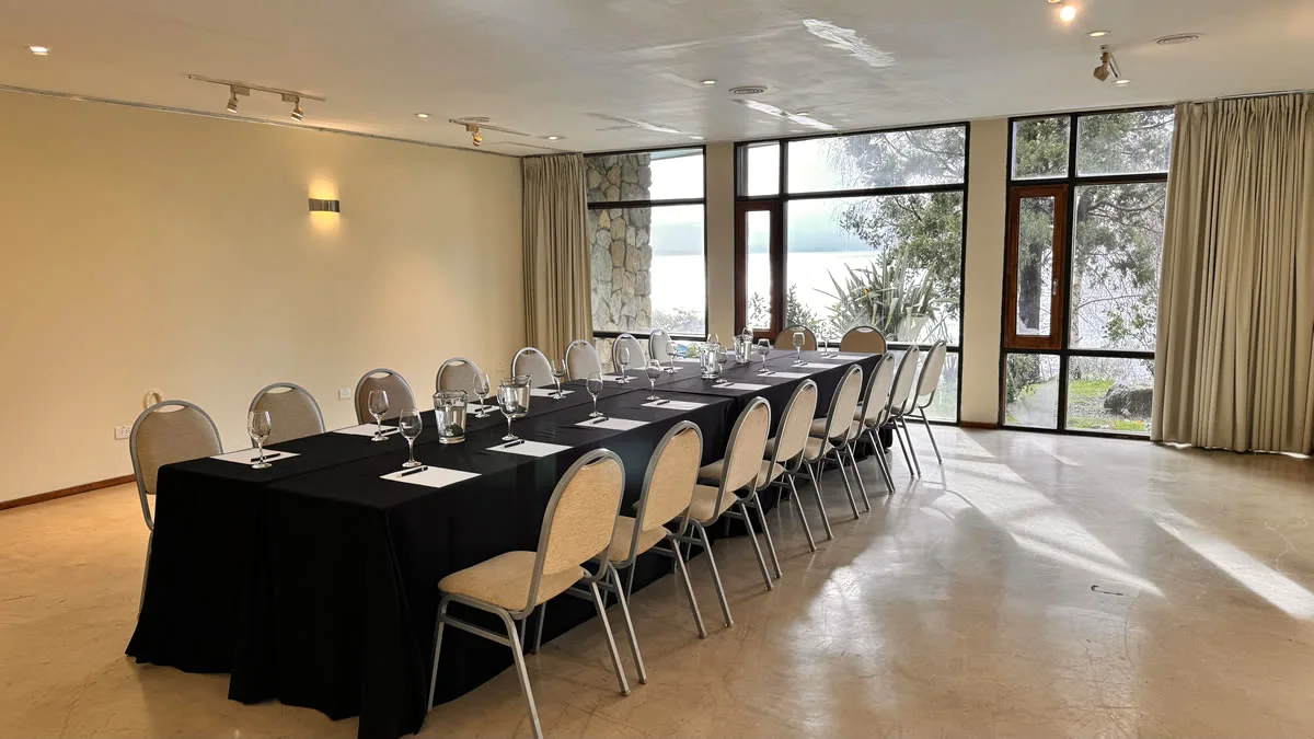 Bright event room with floor-to-ceiling windows at Design Suites Bariloche, Argentina