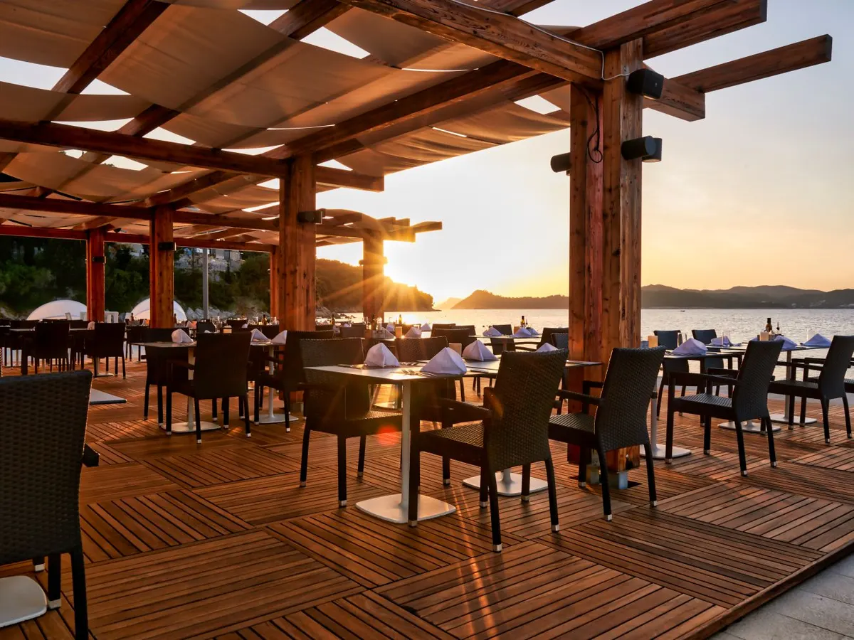 Terrace dining at sunset over the bay at Hilton Lopud Beach Resort, Croatia
