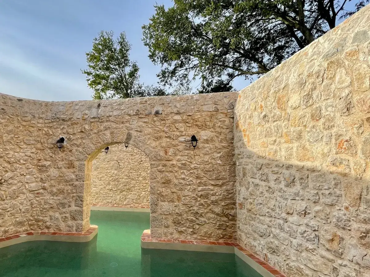 Stone archway beside the outdoor swimming pool at Hotel Balatura, Vinodol Valley, Croatia