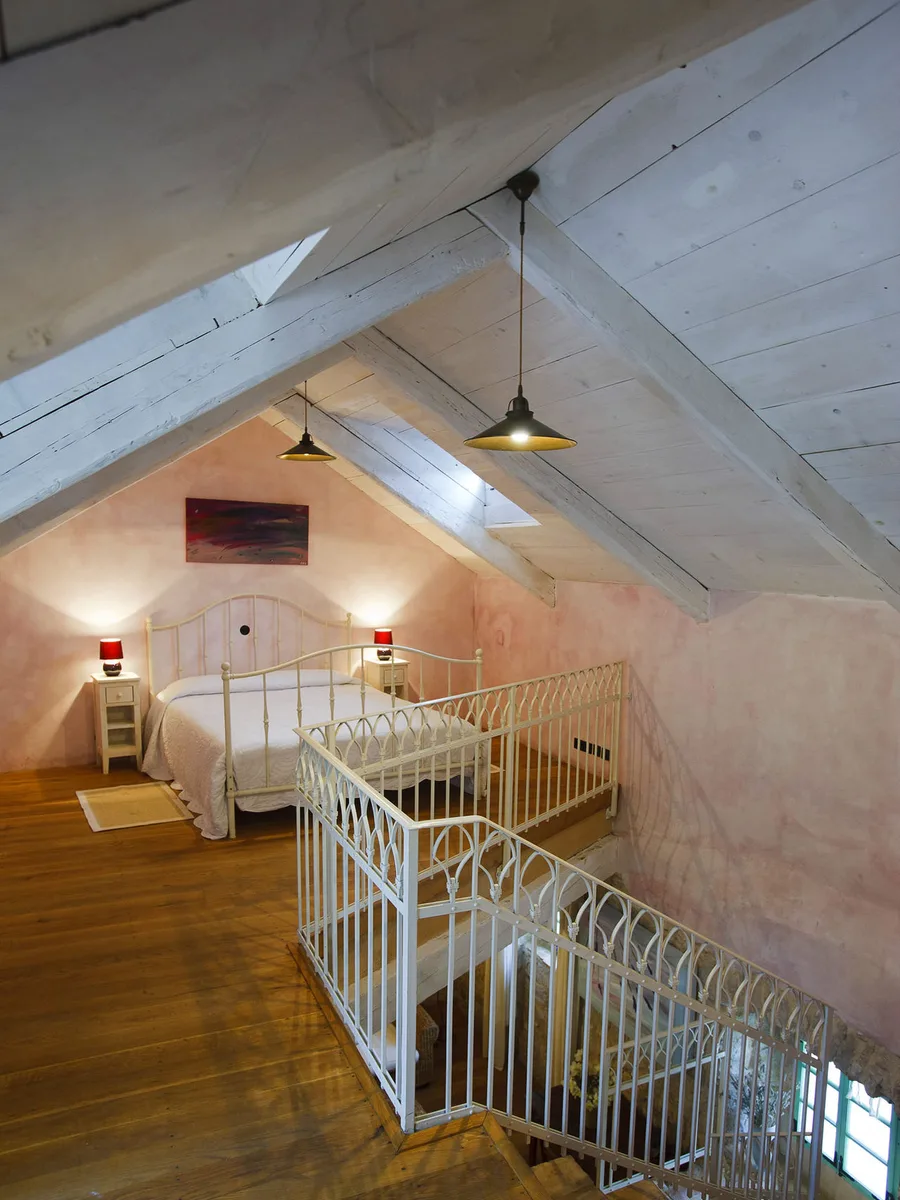 Attic guest room under exposed wood beams at Hotel Balatura, Tribalj, Croatia