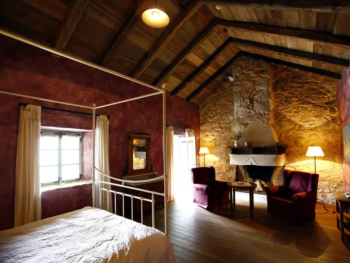 Guest room with its own fireplace and armchairs at Hotel Balatura, Croatia