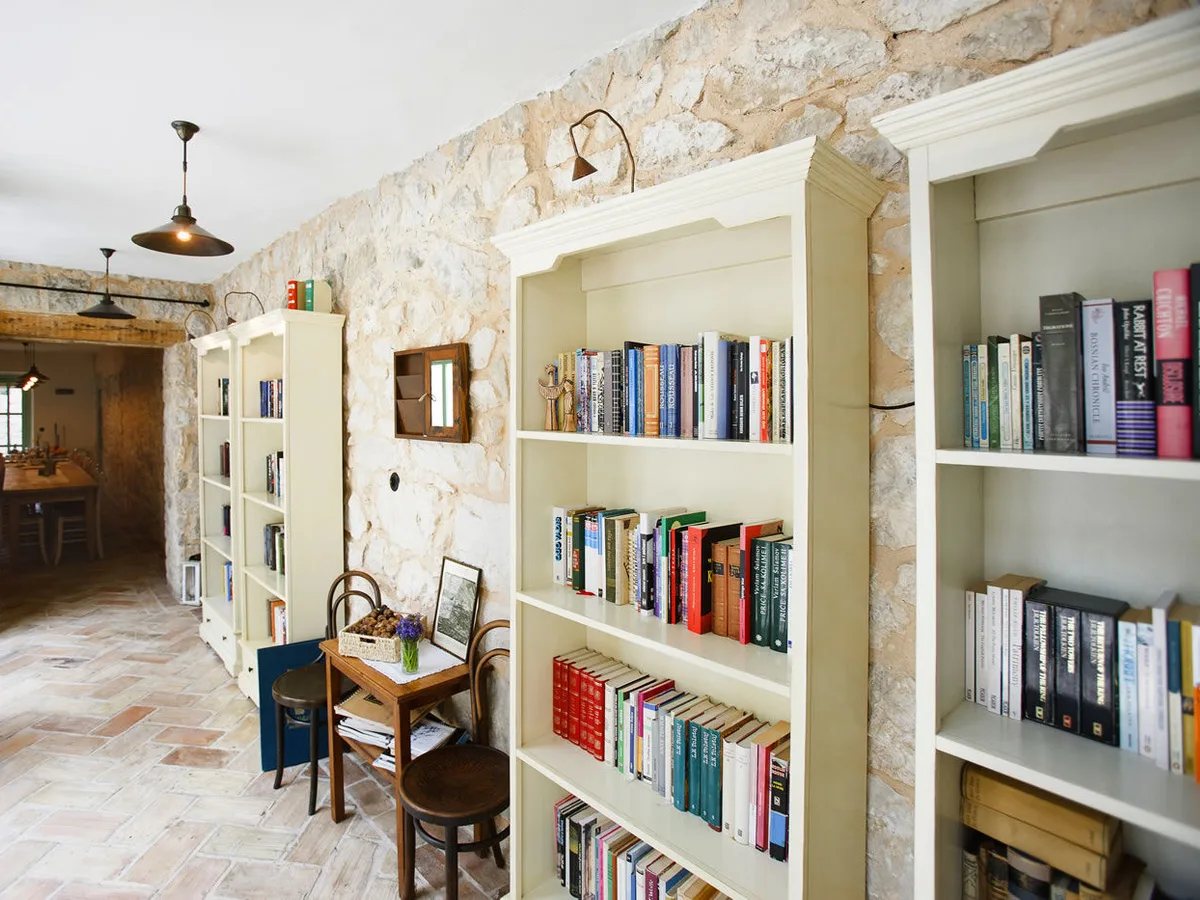 Library and reading room with floor-to-ceiling bookshelves at Hotel Balatura, Croatia