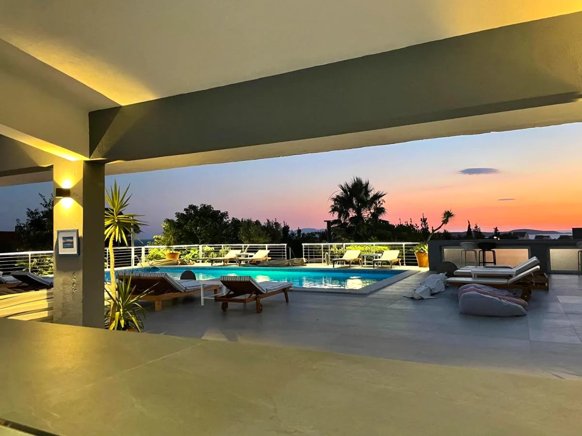 Pool terrace at sunset from the covered lounge at B&B Dela, Hvar Town, Croatia
