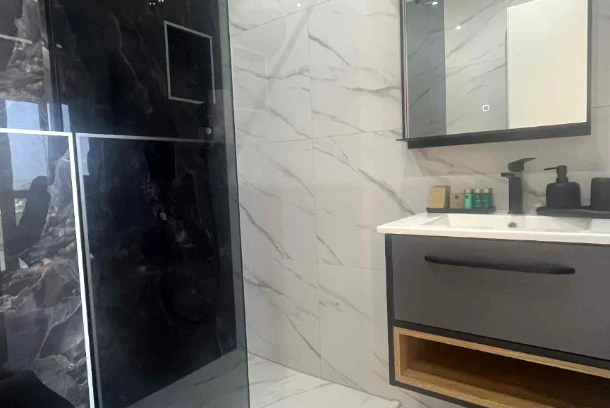 Modern en-suite bathroom with black marble shower and vanity at B&B Dela, Hvar Town, Croatia