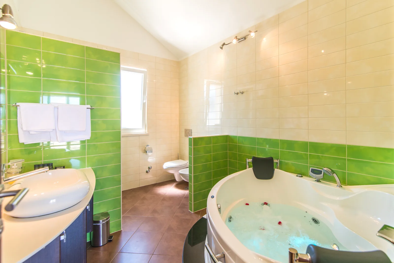 En-suite bathroom with a massage bathtub at Villa Gumonca, Brač Island, Croatia