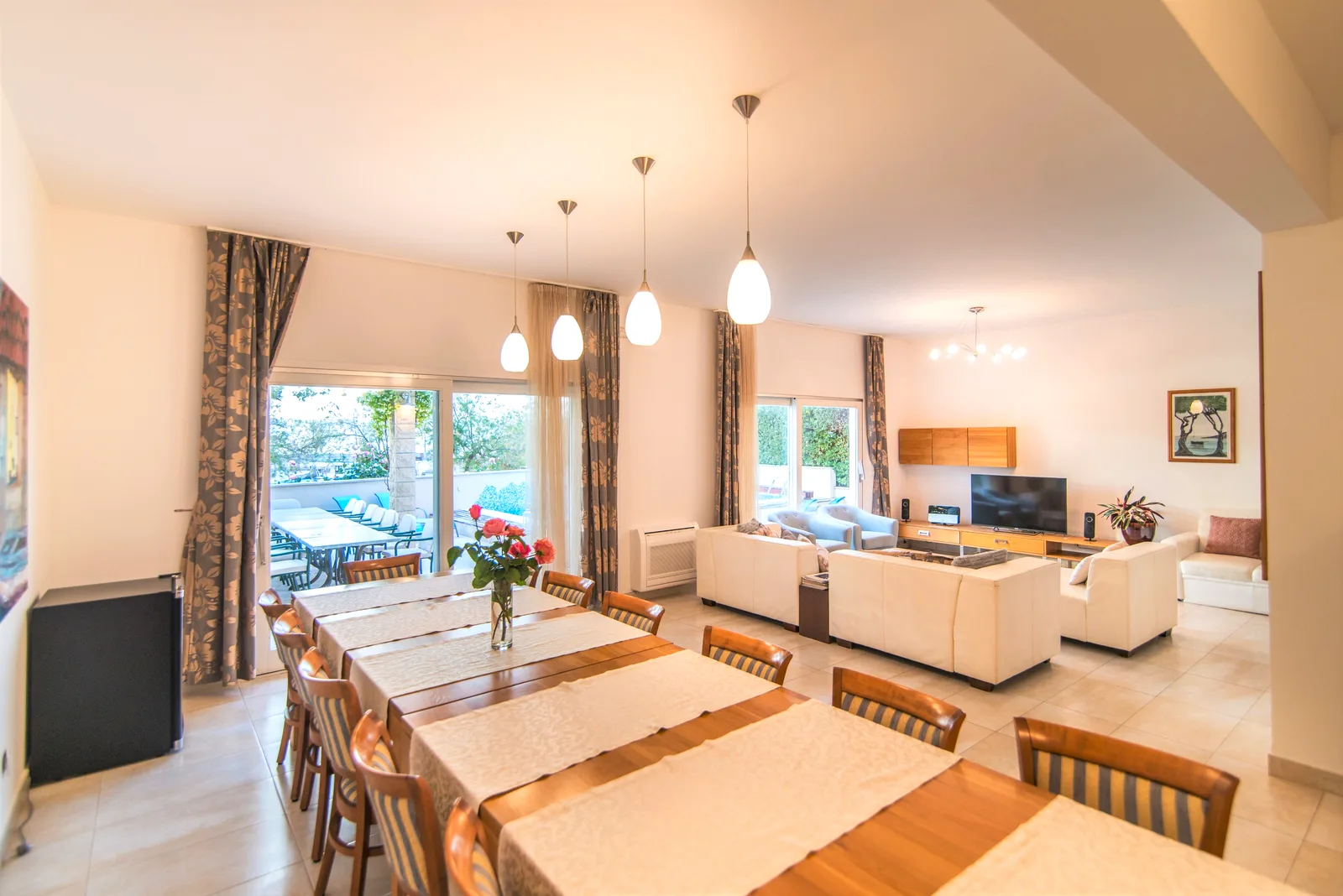 Long dining table seating the whole group, opening into the living room at Villa Mirca, Brač Island