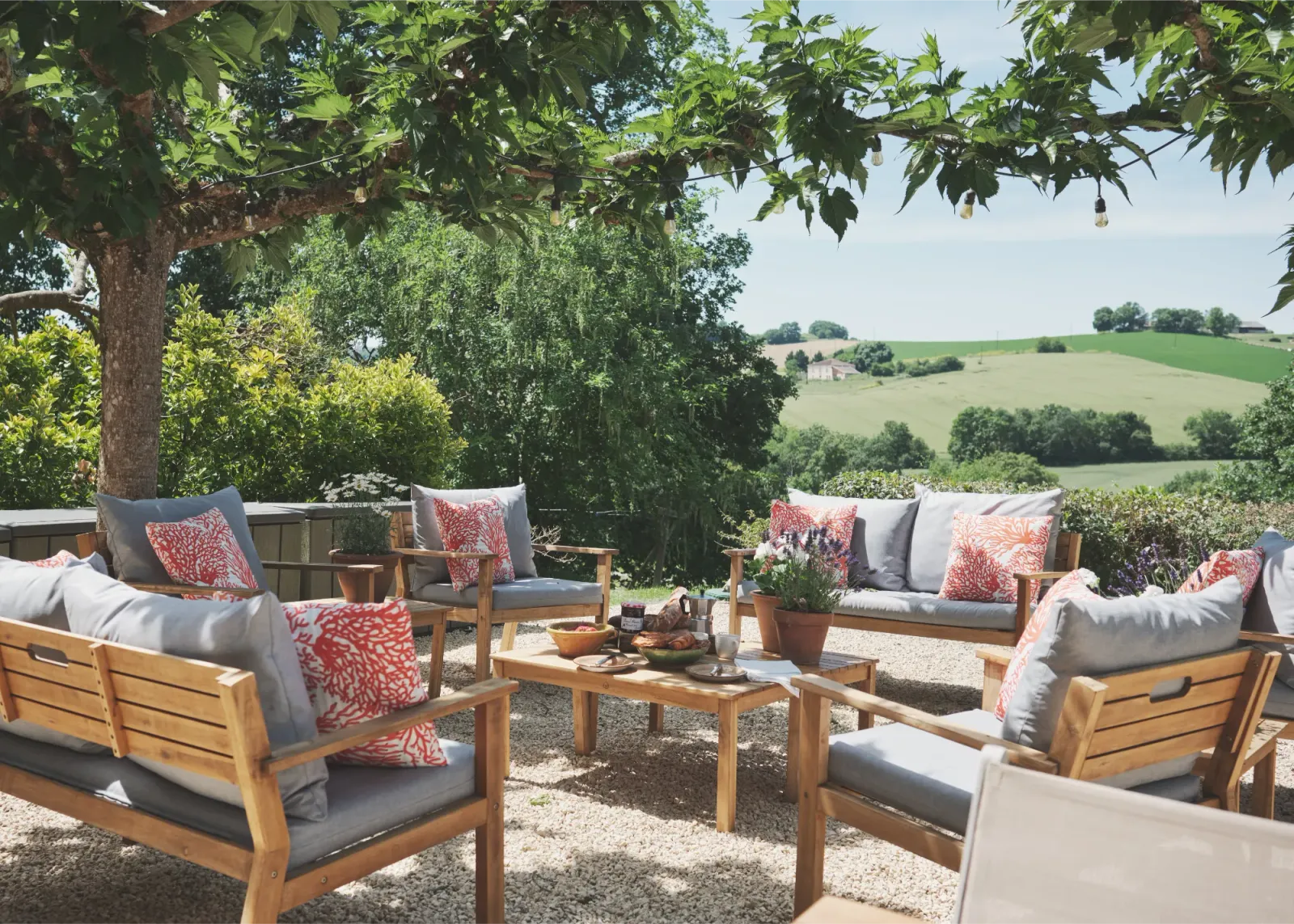 Terrace with outdoor seating overlooking the countryside at Château de Lassalle, France