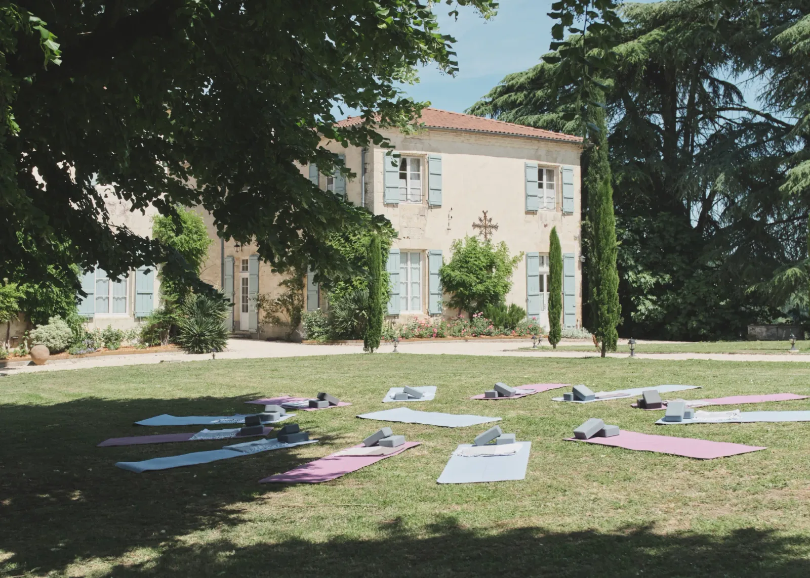 Yoga mats laid out on the lawn in front of Château de Lassalle, France