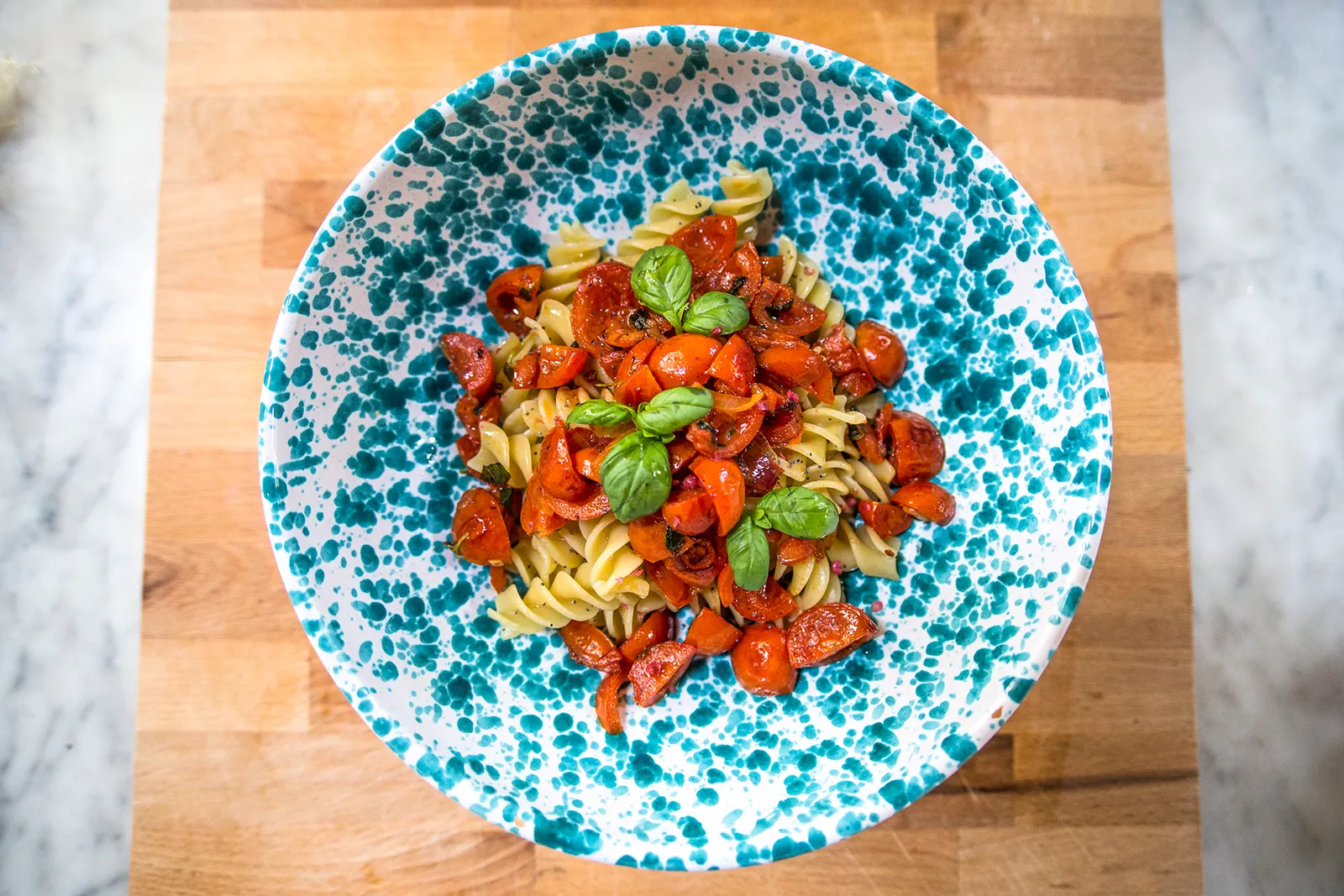 Fresh tomato and basil pasta on a Sicilian ceramic plate at Sicilian Spirit