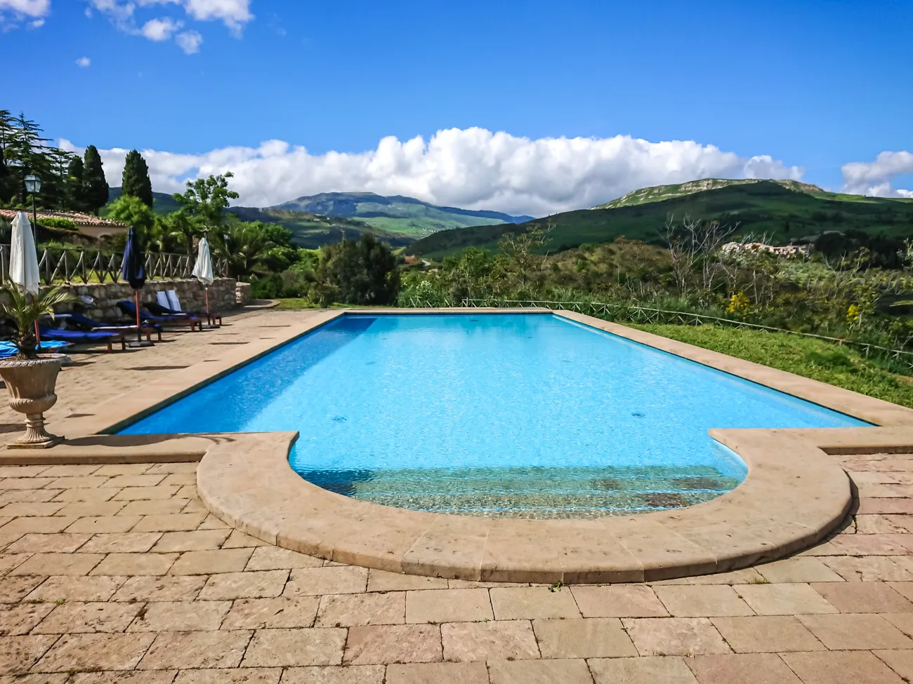 Outdoor pool and stone terrace overlooking the hills at Sicilian Spirit, Sicily