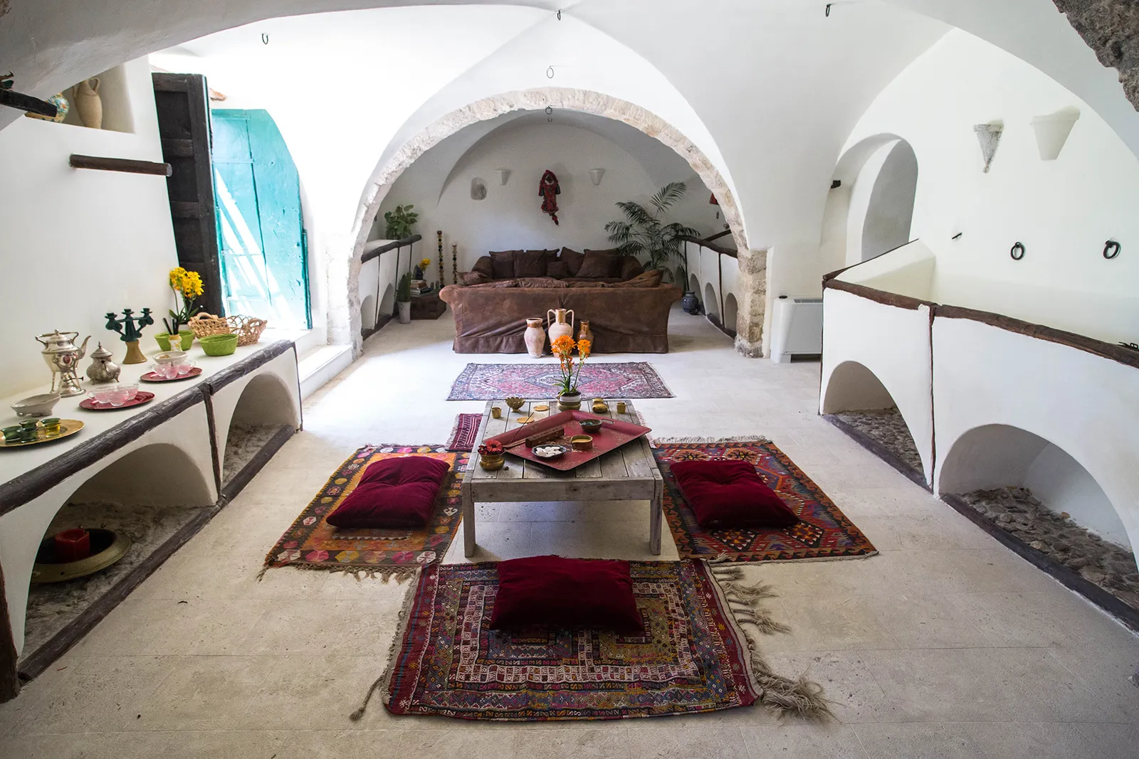 Tea room lounge with sofas, rugs and cushions at Sicilian Spirit, Sicily
