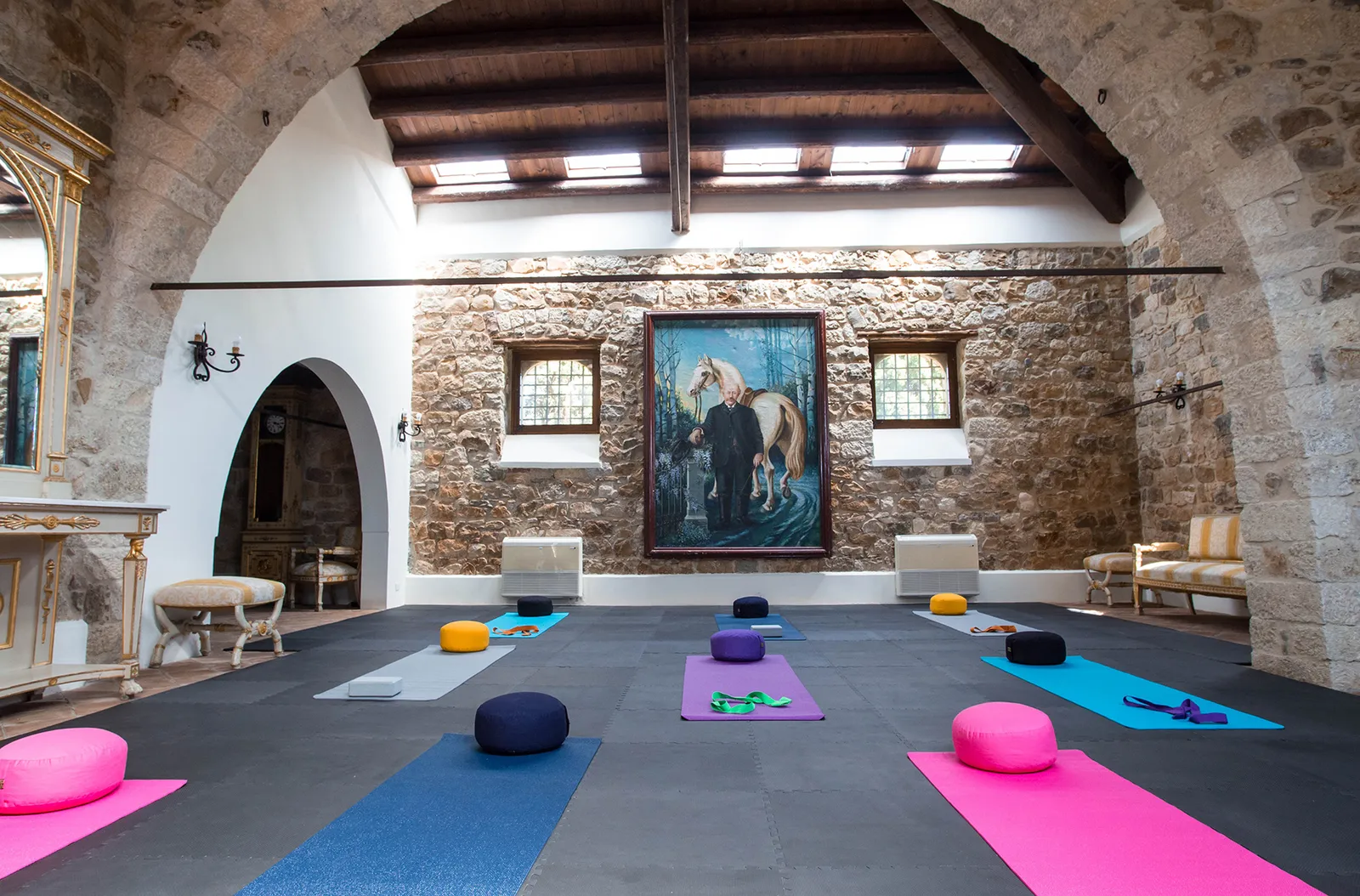 Stone-walled yoga room in the converted barn at Sicilian Spirit, Sicily, with mats and cushions laid out