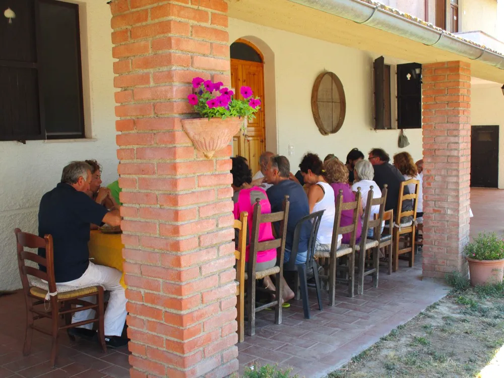 Group dinner under the pergola at Il Risveglio, Tuscany