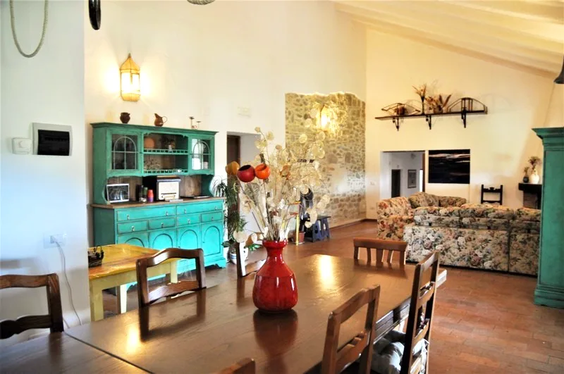 Farmhouse dining room with a vintage teal dresser at Il Risveglio, Tuscany