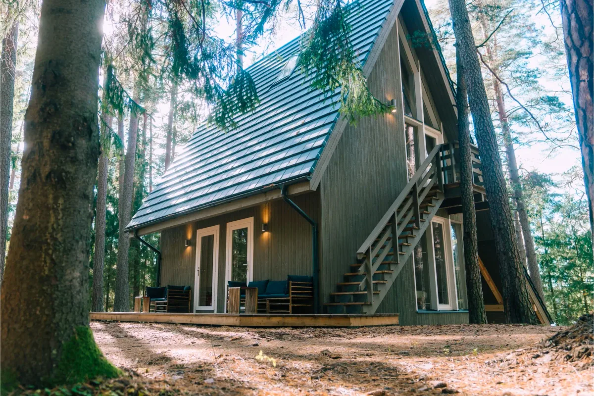 Little House, a green A-frame cabin, among the pines at Šiaurys Resort, Lithuania
