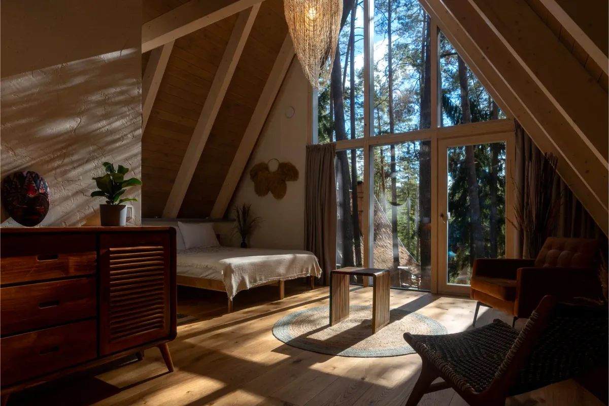 A-frame bedroom with a cathedral ceiling and forest views in Little House at Šiaurys Resort, Lithuania