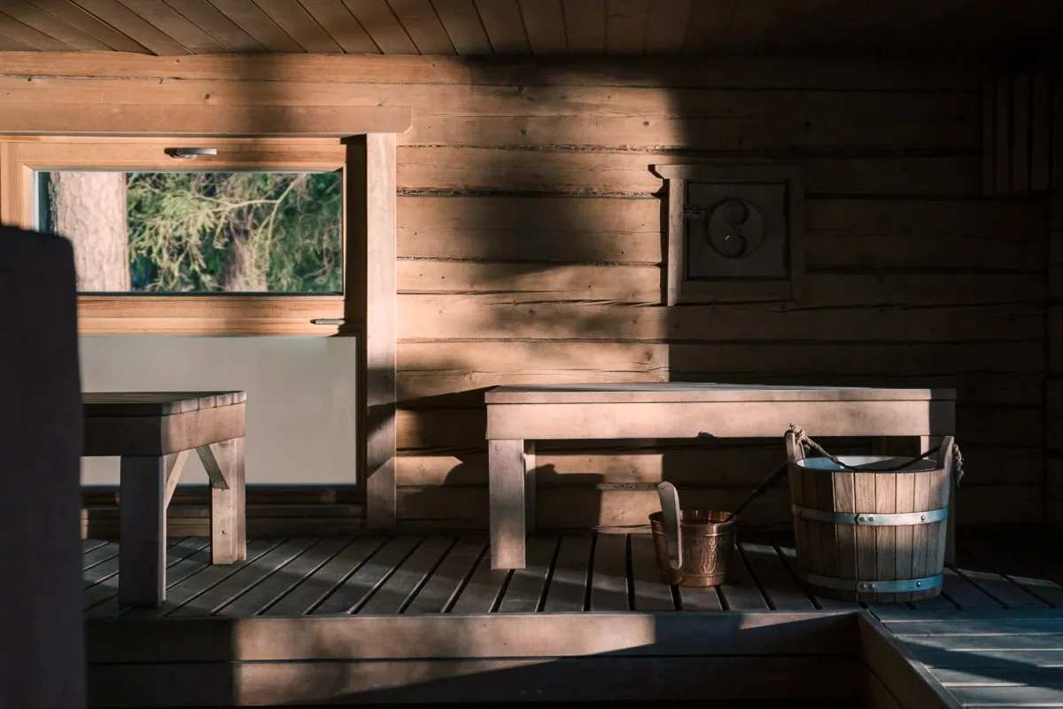 Traditional wood-fired sauna interior with cedar benches at Šiaurys Resort, Lithuania