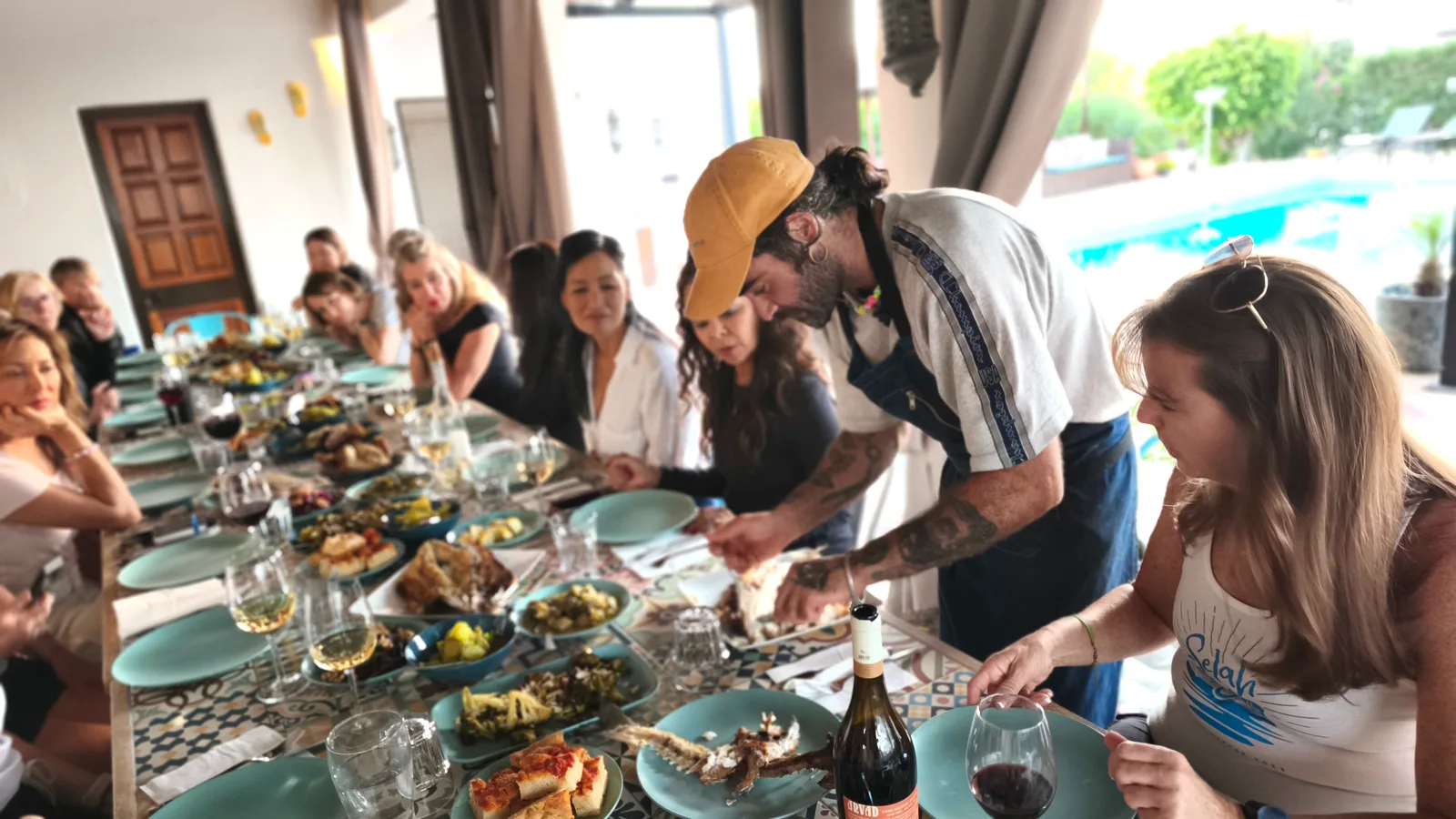 Chef serving guests at a retreat dinner at Villa Vale a Pena, Algarve