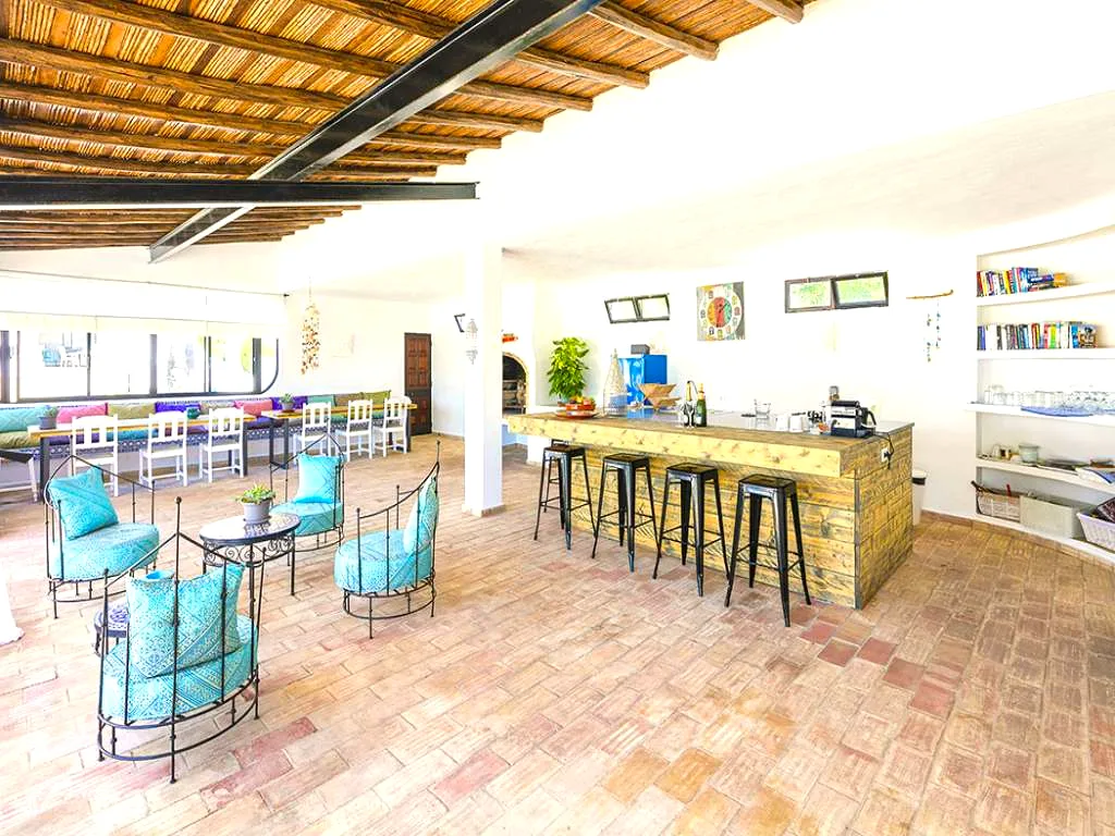 Poolside lounge and bar with a reed-thatched ceiling at Villa Vale a Pena, Algarve, Portugal