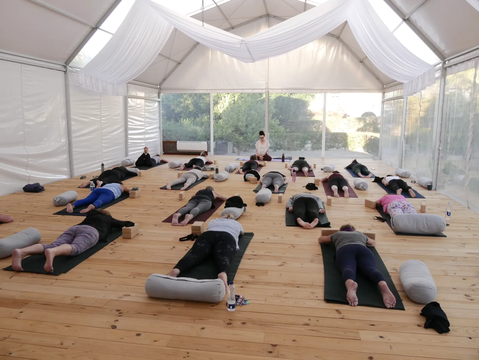 Group yoga practice inside the covered tent at Villa Vale a Pena, Algarve, Portugal