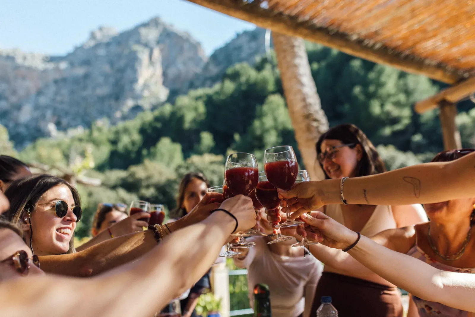Retreat group toasting together under the pergola at Finca Higo, Mallorca