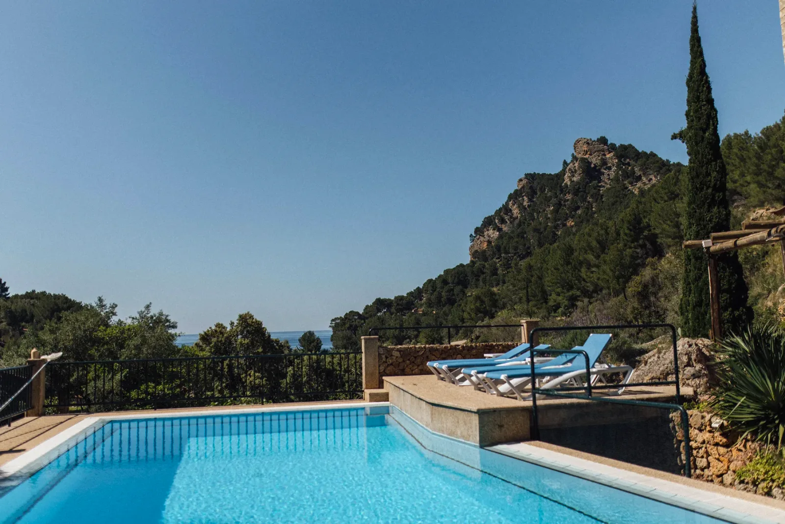 Pool framed by cypress trees with the Tramuntana mountains behind, Finca Higo, Mallorca