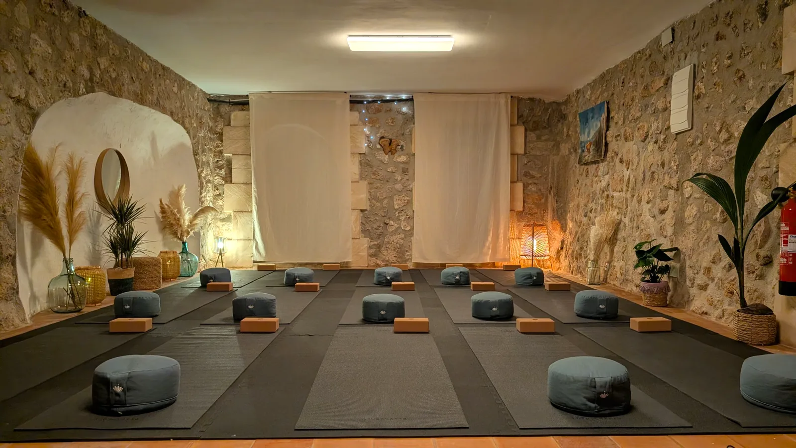 Indoor yoga studio with mats and cushions at Finca Higo, Mallorca