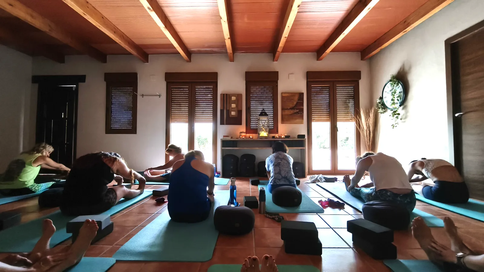 Group yoga class in the indoor yoga shala at the Oodles villa, Spain