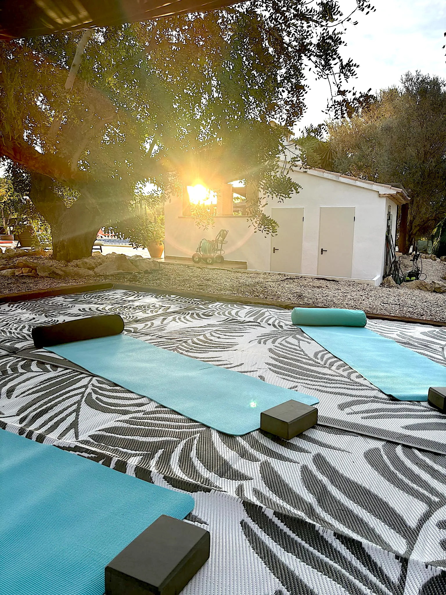 Yoga mats set out at sunrise on the outdoor deck at the Oodles villa, Spain