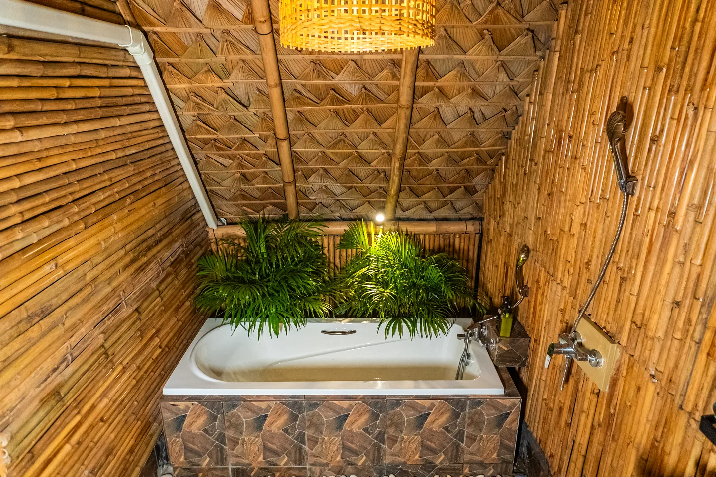 Bungalow bedroom with bamboo ceiling and fairy lights at Shivari, Koh Phangan