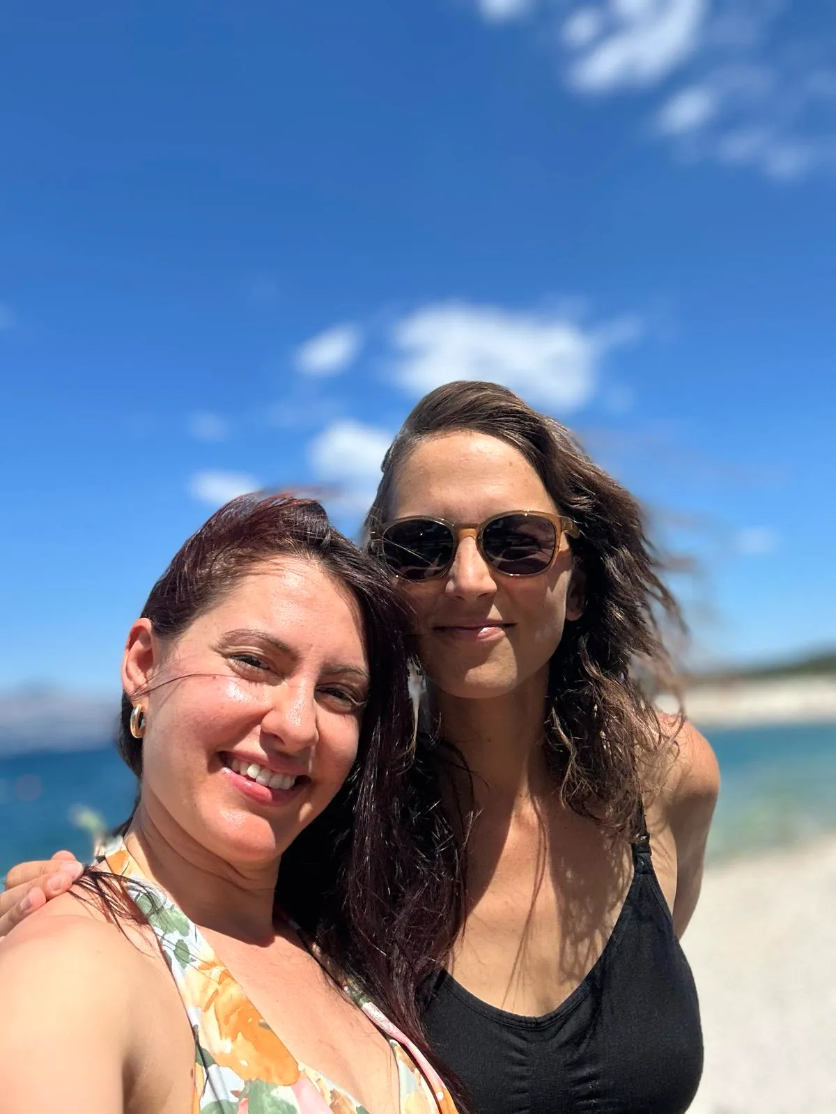 Two retreat guests smiling at the beach on a sunny day, Brač Island
