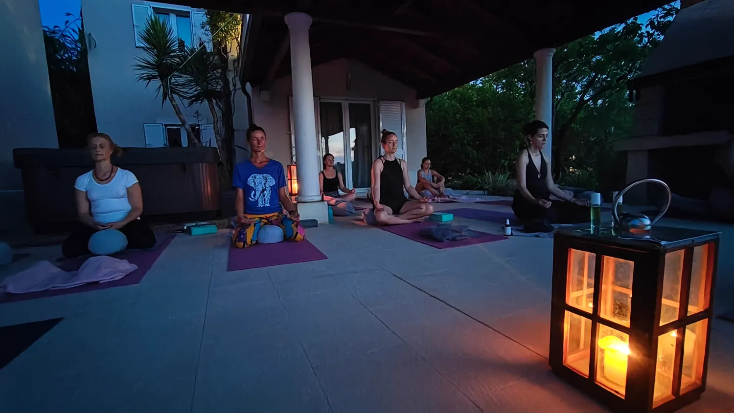 Candlelit evening meditation on the terrace at dusk, Brač Island