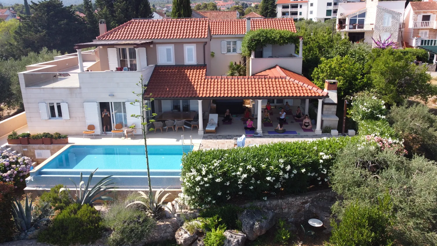 Aerial view of the retreat villa, pool and morning yoga on the terrace, Brač Island, Croatia