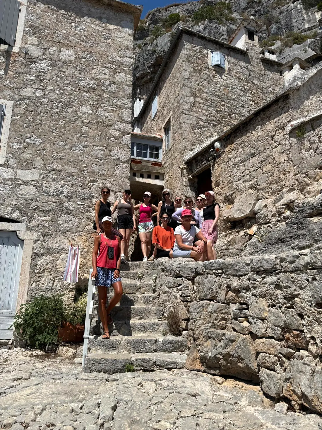 Retreat group on the stone steps of a historic Brač Island village