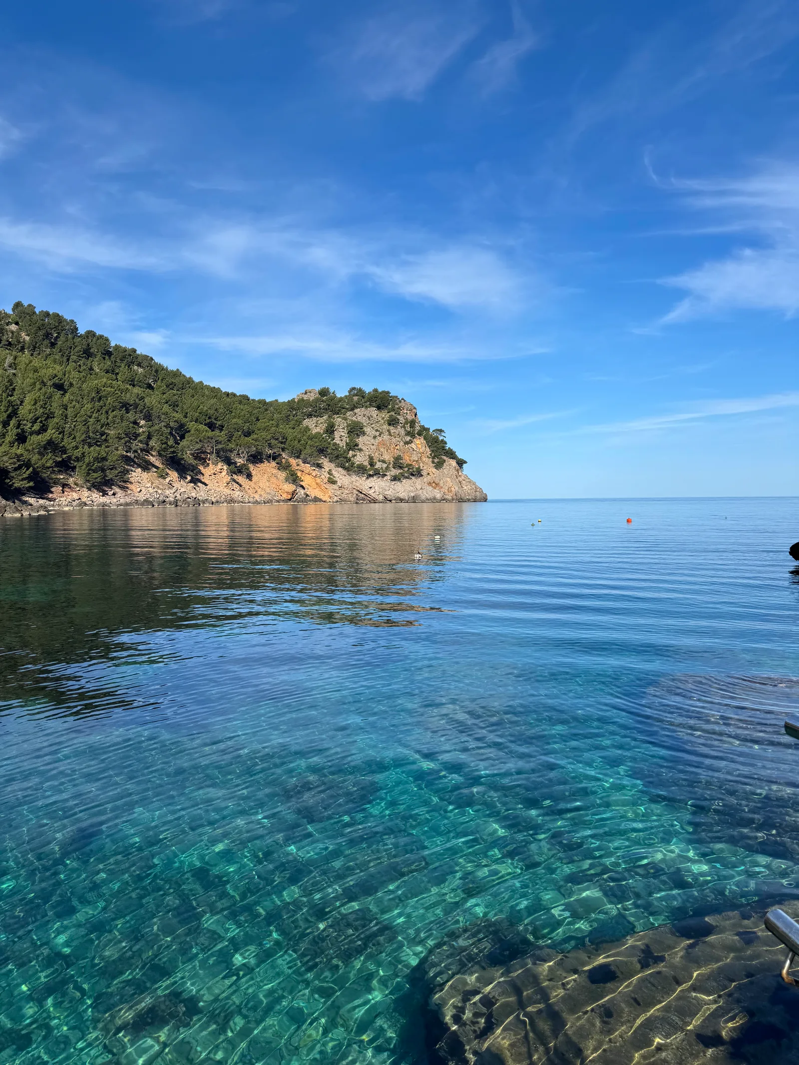 Turquoise cove and pine headland on Mallorca, Spain — Green Yogi Traveler retreat