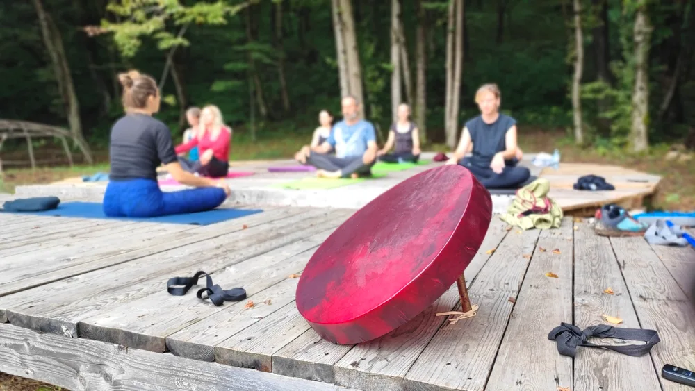 Group meditation on a riverside deck at the Mrežnica weekend retreat, Croatia