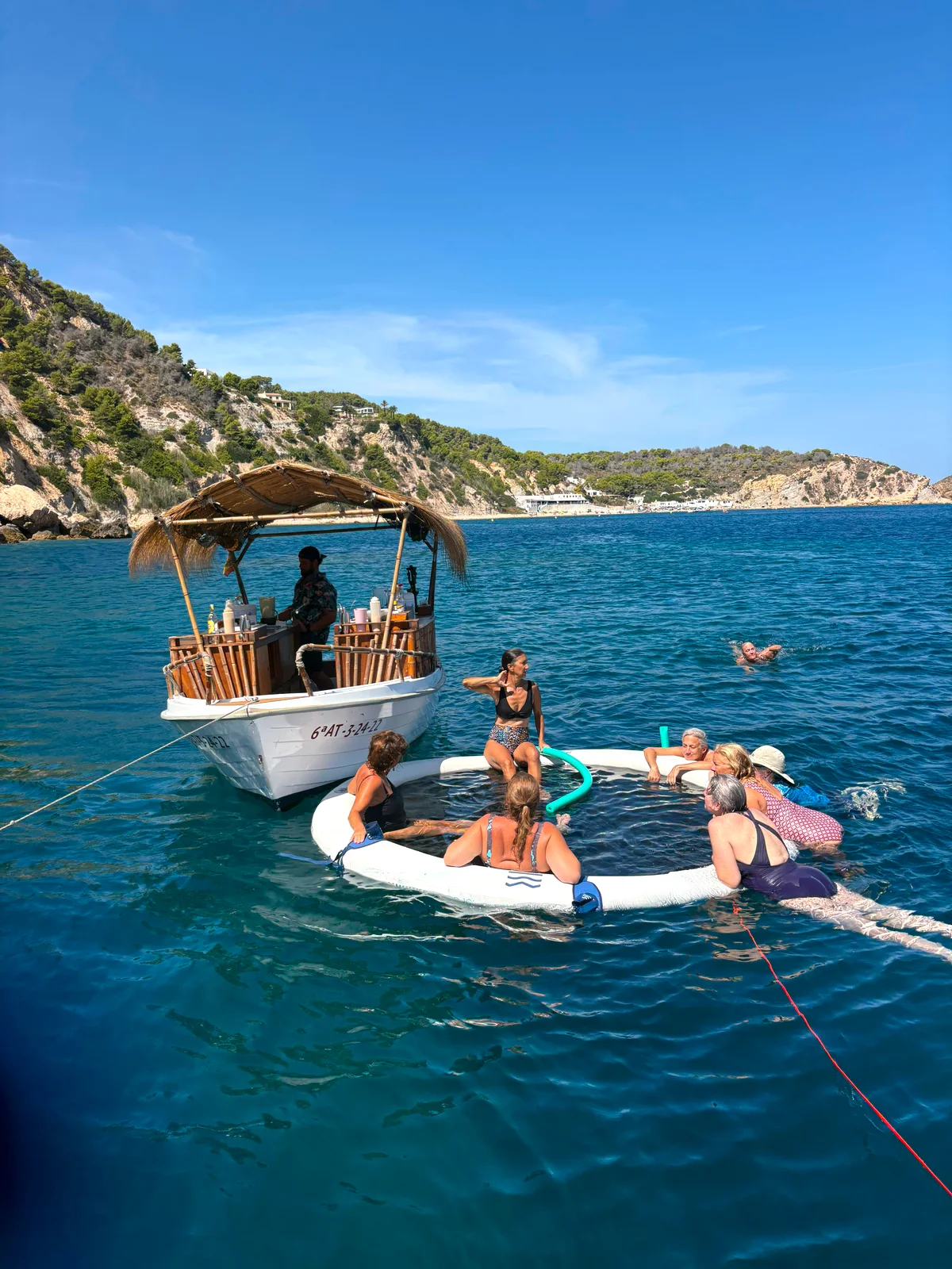 Floating pool and boat trip in a cala on the Costa Blanca, Spain